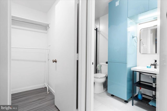 bathroom with tile patterned flooring and toilet