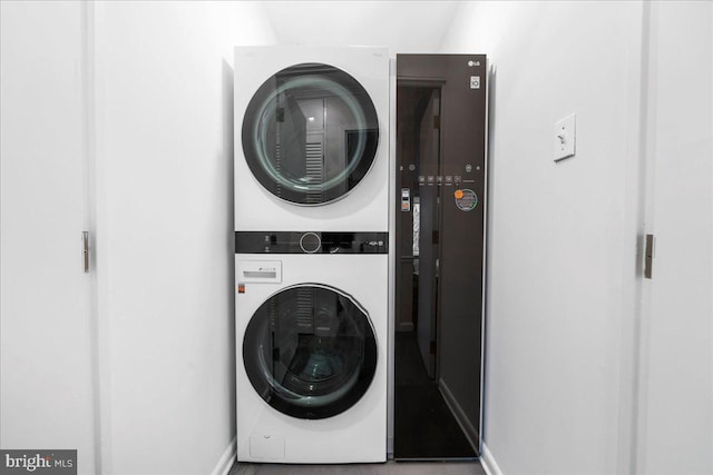 laundry area with stacked washing maching and dryer