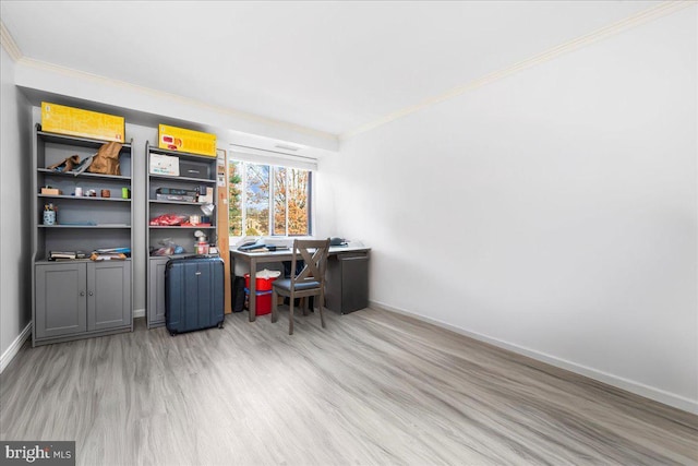 office area featuring light wood-type flooring and ornamental molding