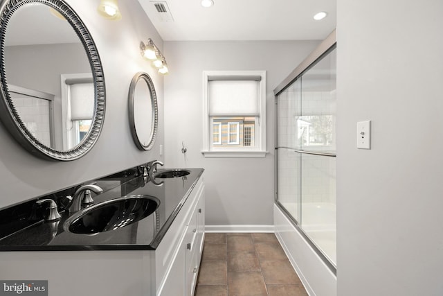 bathroom with shower / bath combination with glass door, vanity, and tile patterned floors