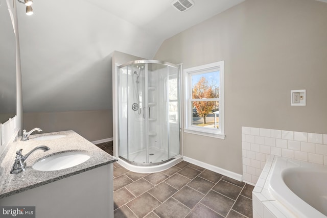 bathroom featuring vanity, separate shower and tub, and lofted ceiling