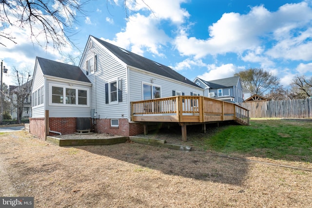 rear view of house with a lawn, cooling unit, and a wooden deck