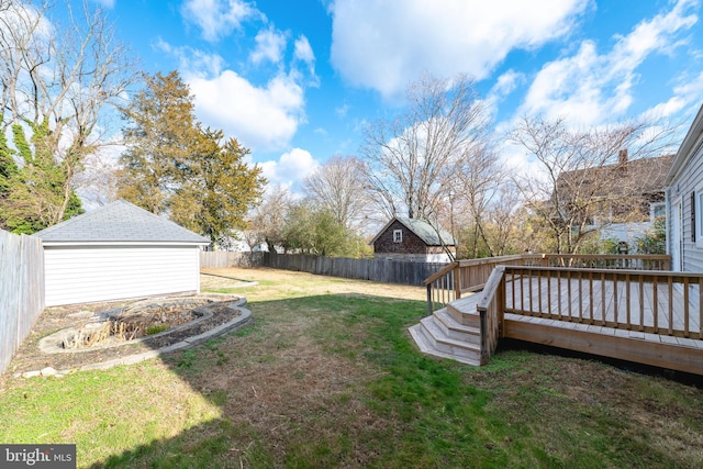 view of yard with an outdoor structure and a wooden deck