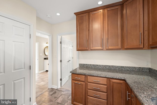 kitchen featuring dark stone countertops