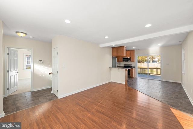 unfurnished living room with dark wood-type flooring