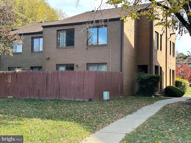 view of property exterior with a lawn