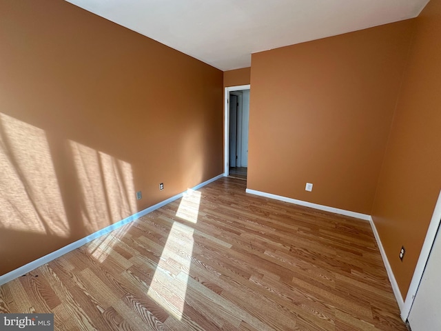 unfurnished room with light hardwood / wood-style floors