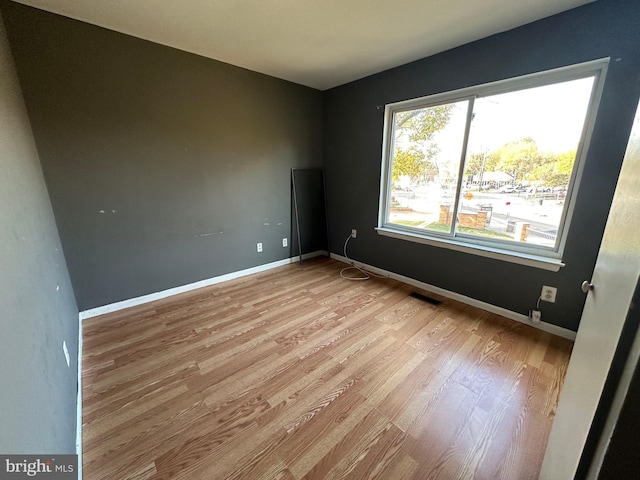 spare room featuring light wood-type flooring