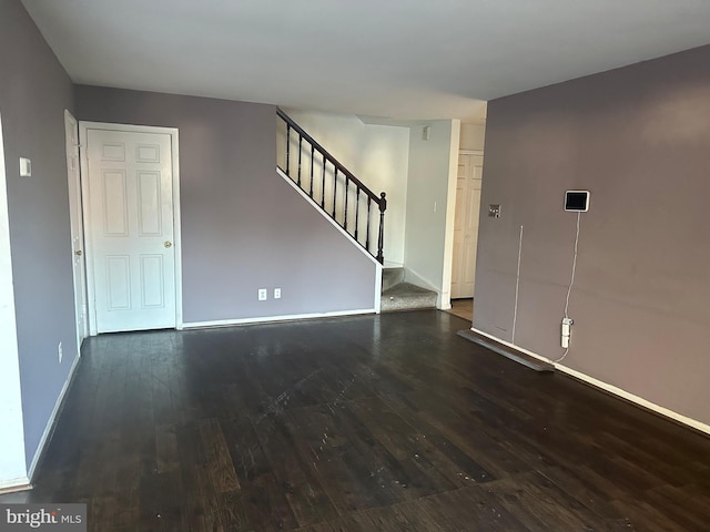 unfurnished room featuring dark wood-type flooring