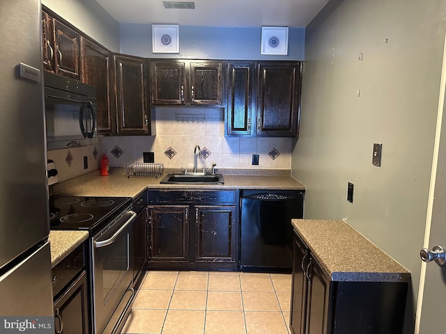 kitchen featuring backsplash, black appliances, sink, light tile patterned floors, and dark brown cabinets