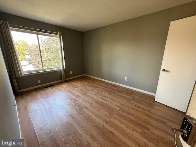 empty room with wood-type flooring