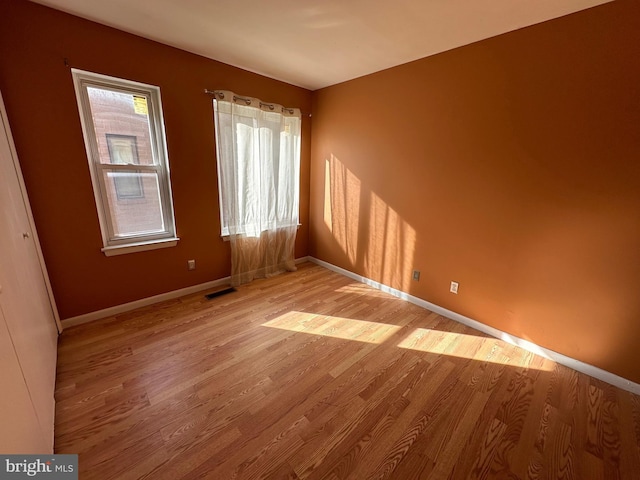 empty room with a healthy amount of sunlight and light wood-type flooring