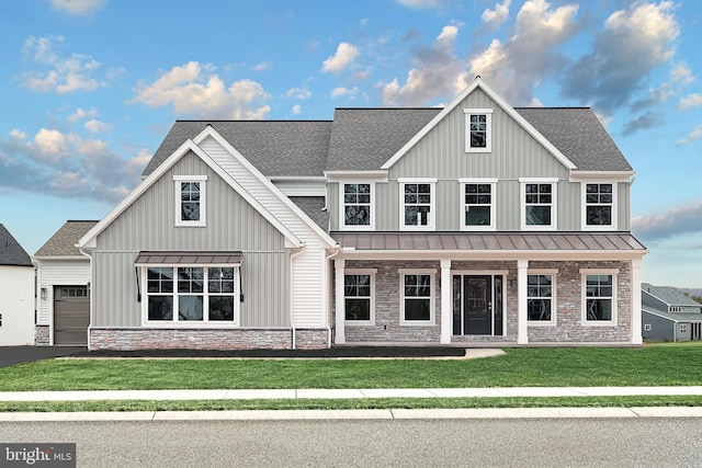 modern farmhouse with a porch, a garage, and a front yard