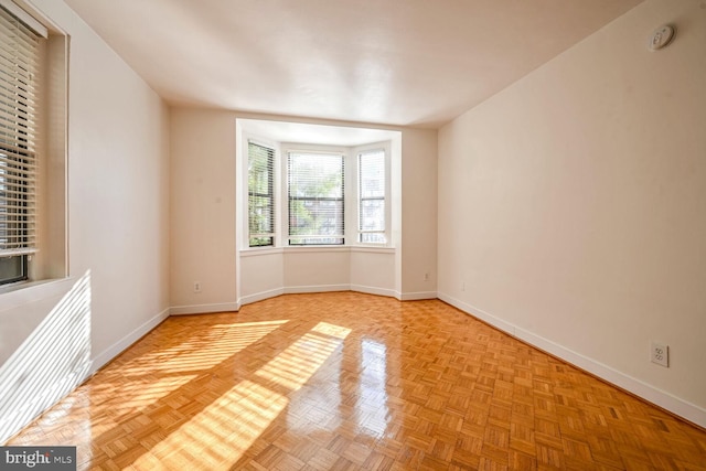 unfurnished room featuring light parquet flooring