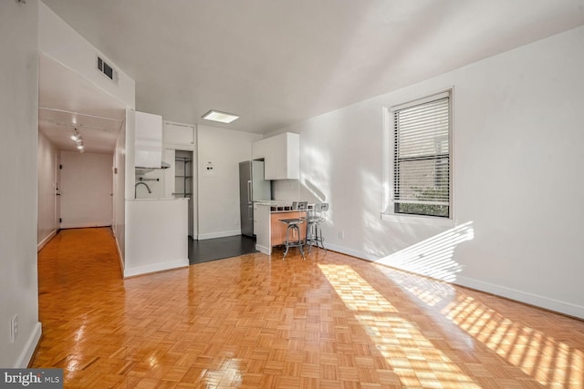 empty room featuring sink and light parquet flooring