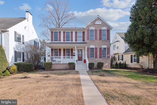 view of front facade featuring a front lawn and a porch