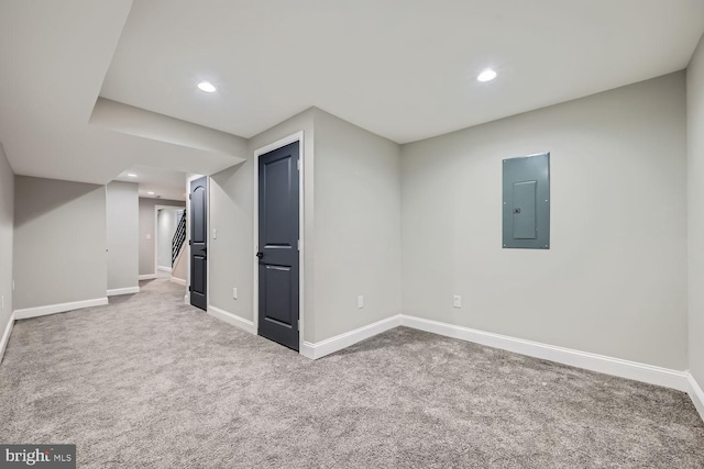 basement featuring electric panel and carpet