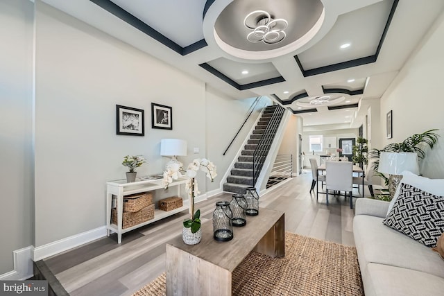 living room featuring beam ceiling, wood-type flooring, and coffered ceiling