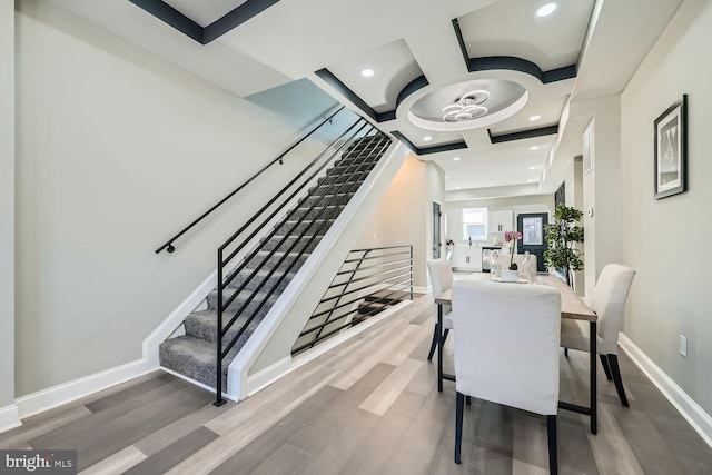 stairway featuring hardwood / wood-style floors and coffered ceiling