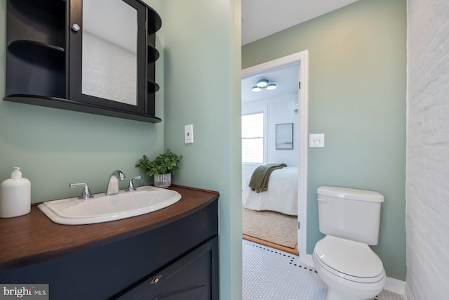 bathroom featuring tile patterned flooring, vanity, and toilet