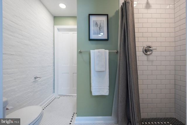 bathroom with toilet, tile patterned floors, and curtained shower