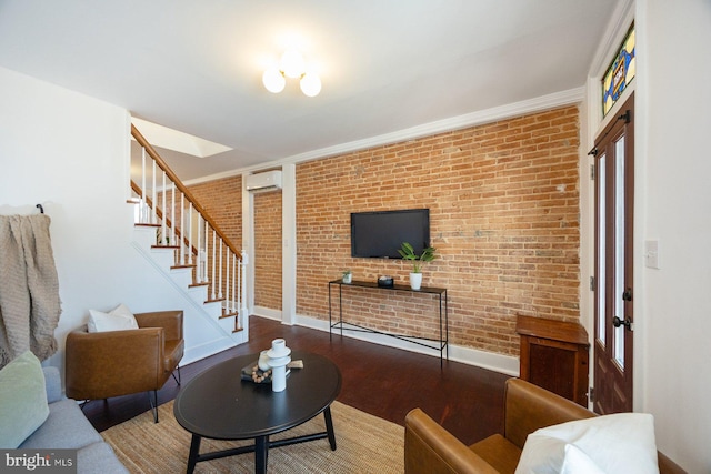 living room with a wall mounted air conditioner, wood-type flooring, and brick wall