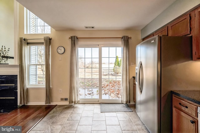 entryway with a fireplace, plenty of natural light, and light wood-type flooring