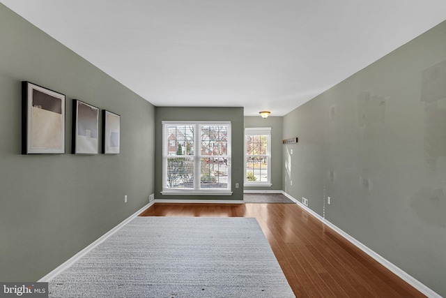 spare room featuring wood-type flooring