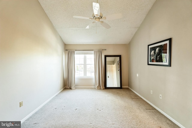 spare room featuring light carpet, a textured ceiling, and ceiling fan