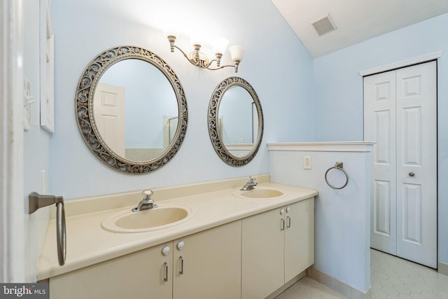 bathroom featuring vanity and lofted ceiling