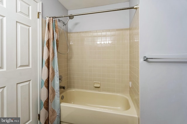 bathroom featuring shower / tub combo with curtain