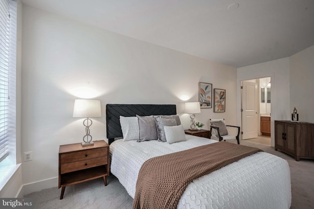 carpeted bedroom with ensuite bathroom