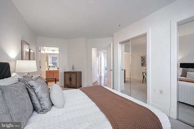 carpeted bedroom featuring connected bathroom