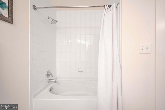 bathroom with shower / bath combo with shower curtain