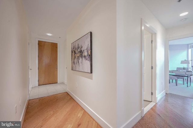 corridor with light hardwood / wood-style flooring