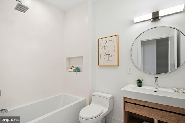 bathroom with vanity, a bath, and toilet