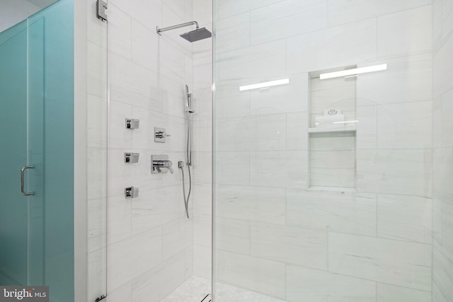 bathroom featuring a shower with door