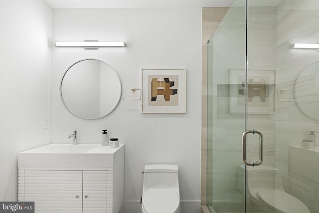 bathroom with vanity, toilet, and a shower with door