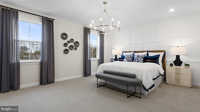 carpeted bedroom featuring an inviting chandelier and multiple windows