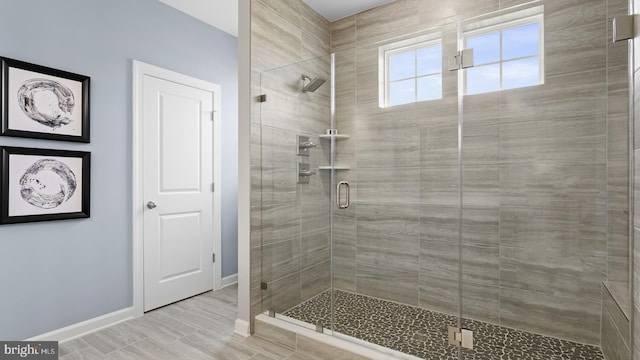 bathroom with wood-type flooring and walk in shower