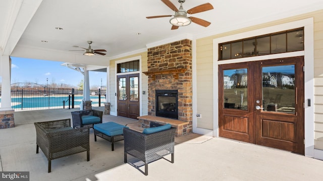 view of patio with french doors, a water view, ceiling fan, and a fenced in pool