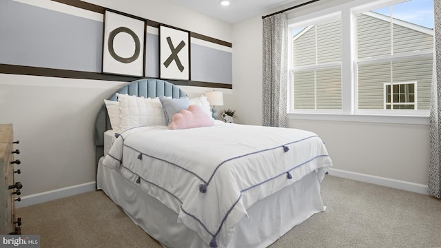 bedroom with light carpet and multiple windows