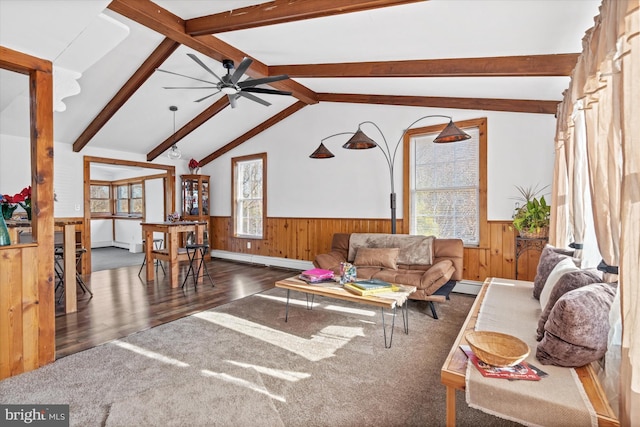 living room featuring ceiling fan, wooden walls, lofted ceiling with beams, a baseboard radiator, and dark hardwood / wood-style floors