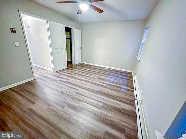 unfurnished bedroom with ceiling fan and light hardwood / wood-style flooring