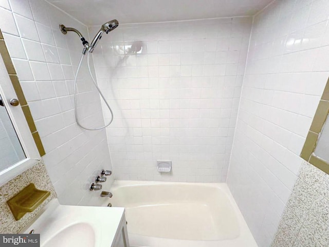 bathroom with vanity and tiled shower / bath combo