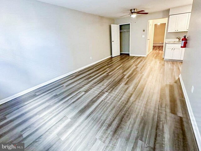 7020 Polk Unit 4, West New York, NJ 07093 - unfurnished living room with wood finished floors, baseboards, and a ceiling fan