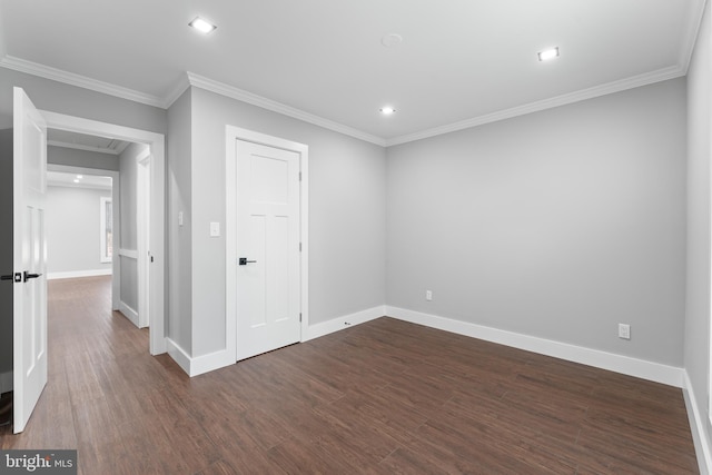 empty room featuring dark hardwood / wood-style floors and ornamental molding