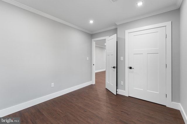 unfurnished bedroom with ornamental molding and dark wood-type flooring