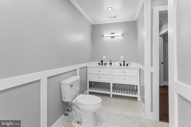 bathroom featuring vanity, toilet, and crown molding