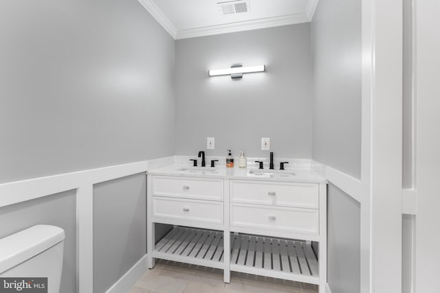 bathroom with vanity, toilet, and crown molding